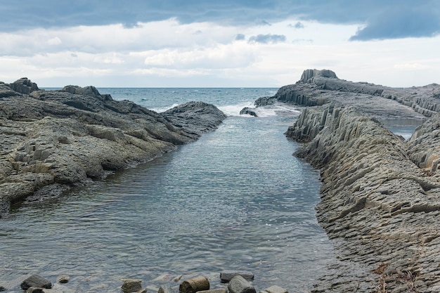 coastal seascape with beautiful columnar basalt rocks at low tide