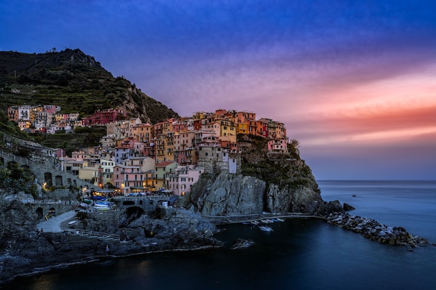 Coastal view at dusk of Manarola Liguria Italy