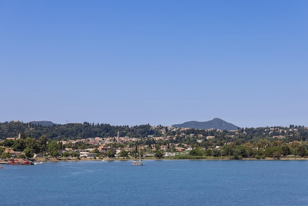 The coastline of Corfu island with urban areas immersed in lush greenery, Ionian islands, Greece