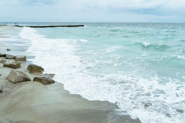 The coastline with concrete slabs on the shore