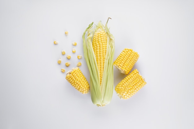 Cobs of ripe corn on a white background