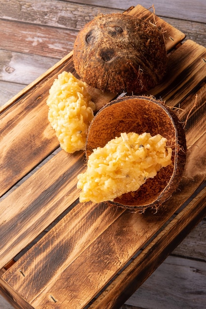 Cocada Brazilian coconutbased candy arranged on a rustic wooden table selective focus