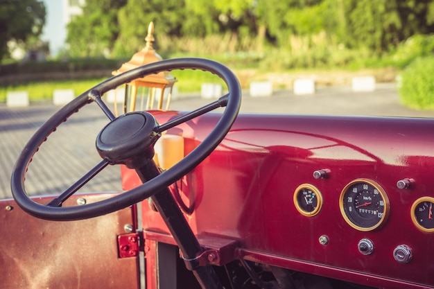 The cockpit and steering wheel of an old car