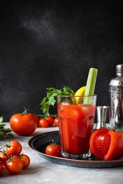 cocktail Bloody Mary with ice, lemon, and celery