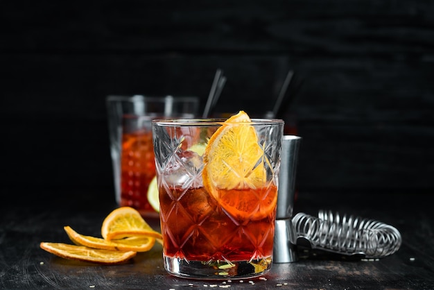 Cocktail Bulvardye Whiskey and Orange Liquor Alcoholic cocktail in a glass On a wooden background Top view Free copy space