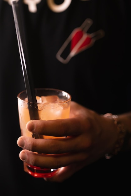 Cocktail in hand of bartender in nightclub