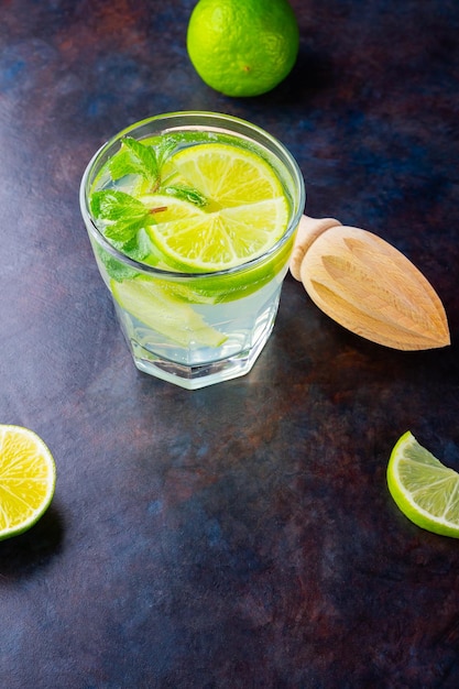 Cocktail mojito with lime and mint in glass One glass of mojito on a dark background