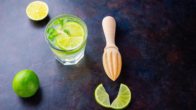 Cocktail mojito with lime and mint in glass One glass of mojito on a dark background