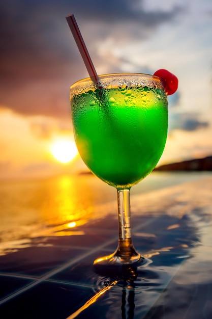 Cocktail near the swimming pool on the background of the Indian Ocean, Maldives.