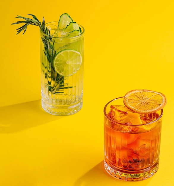 Cocktail Negroni and mojito cocktail on yellow background