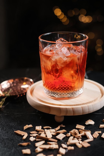 Cocktail served on a wooden board garnished with wood chips Concept of aesthetic drinks serving