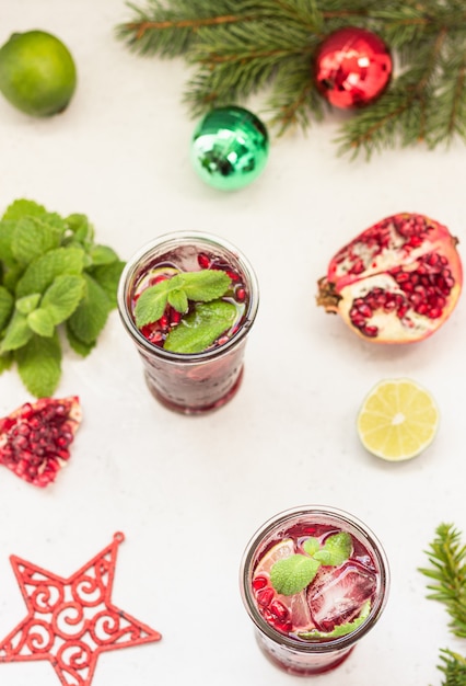 Cocktail with fruit juice, lime, mint, pomegranate