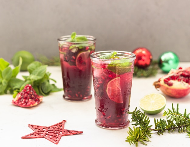 Cocktail with fruit juice, lime, mint, pomegranate