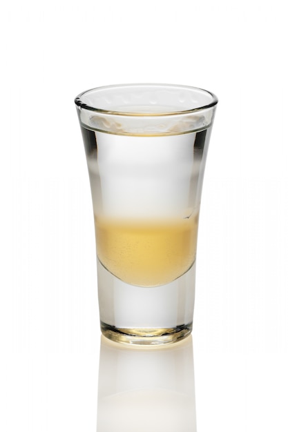 Cocktail with three layers of alcohol in shot glass isolated on white