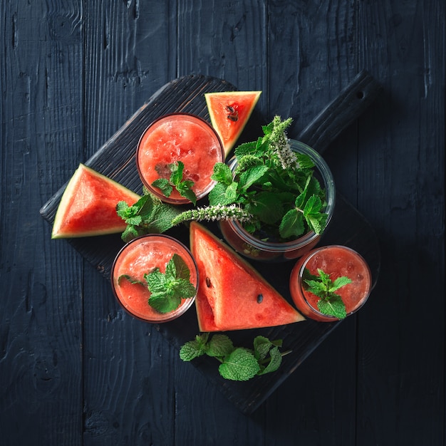 Cocktails drinks watermelon mojito on a dark wooden table top view