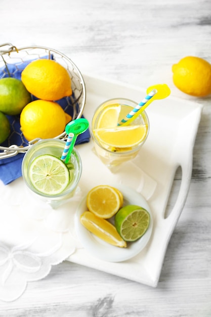 Cocktails with fresh citrus fruits on wooden background