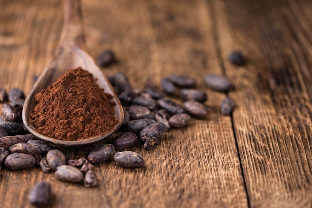 Cocoa powder on wooden background