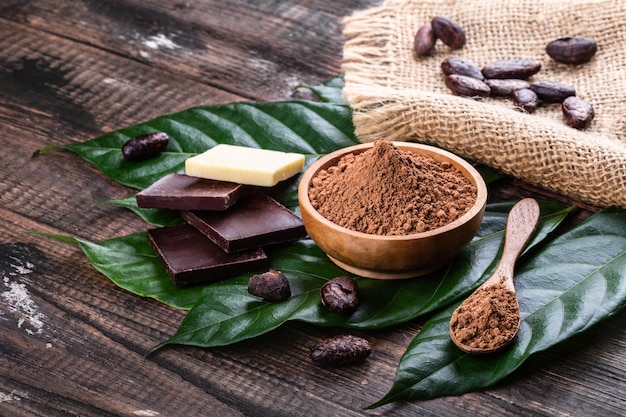 Cocoa products for making home chocolate on old rustic table