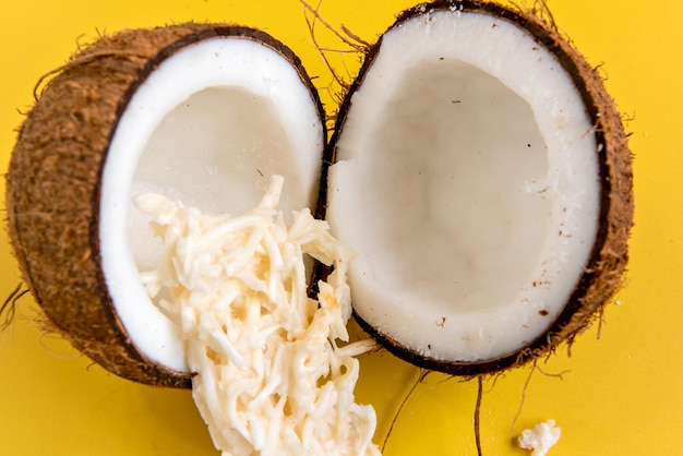 Coconut and coconut candy cocada on a yellow background