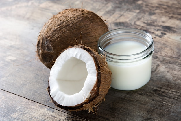 Coconut and coconut milk on wooden table