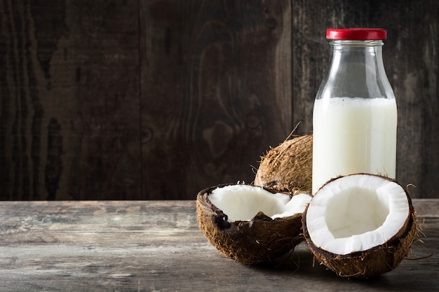 Coconut and coconut milk on wooden table