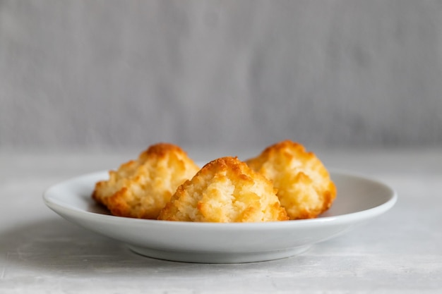 Coconut cookies on a small saucer on ceramic