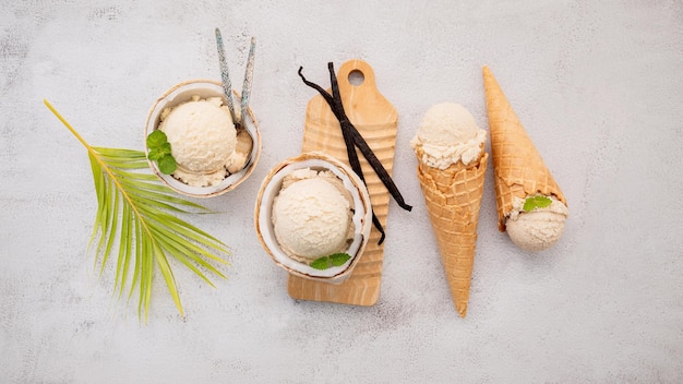 Coconut ice cream flavours in half of coconut setup on white stone background Summer and Sweet menu concept