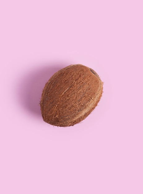 Coconut lies on a pink.