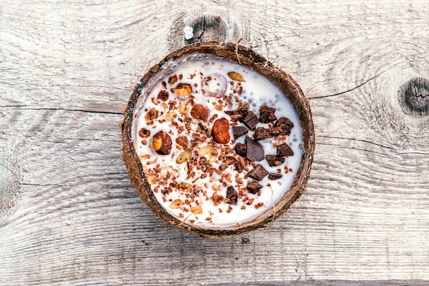 Coconut milk and granola in a coconut shell