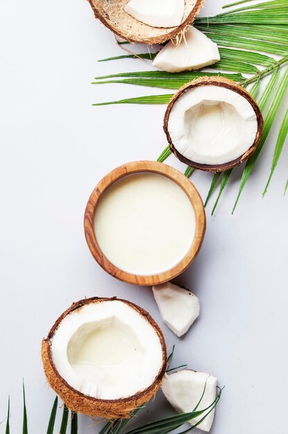 Coconut non dairy vegan milk in wooden bowl Gray backgound top view with copy space hard light