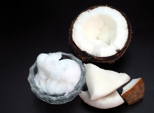 Coconut oil in a bowl and pieces of coconut