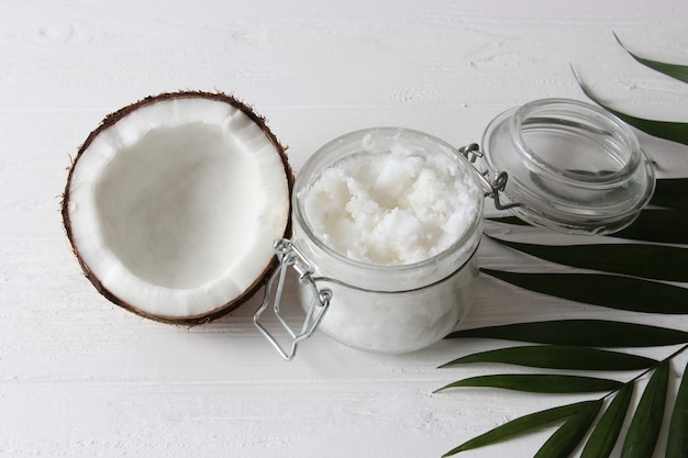 Coconut oil and coconuts palm branches close up