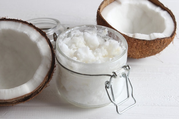 Coconut oil and coconuts palm branches close up