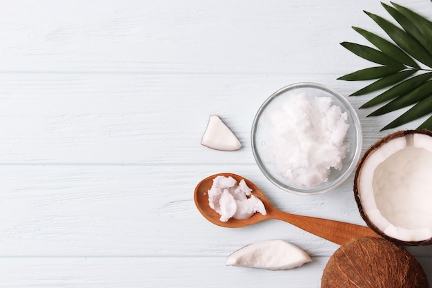 Coconut oil and coconuts palm branches close up