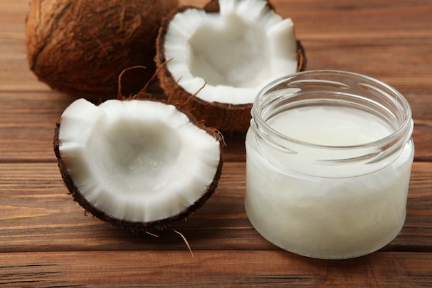 Coconut oil and coconuts on the table