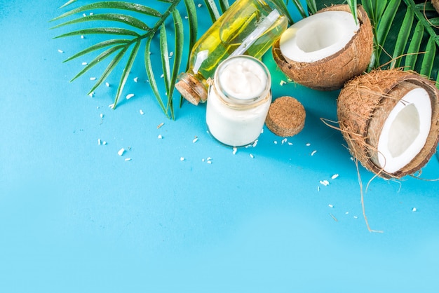 Coconut oil with fresh coconuts. Tropical summer background