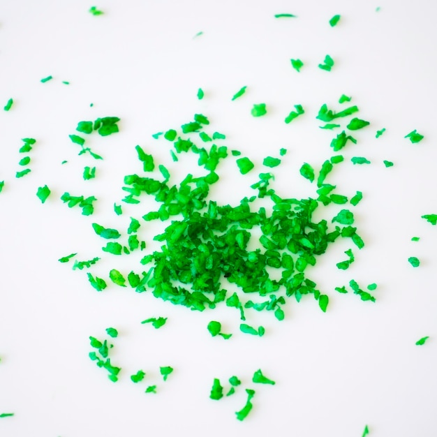 Coconut shavings painted green on a white background Flat lay top view copy space