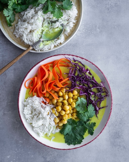 Coconut soup and green curry with chickpeas, basmati rice and vegetables. Homemade food.