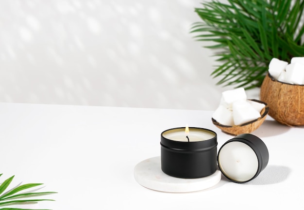 Coconut wax candle in a black jar on a white background natural eco friendly coconut wax candles Trendy concept minimalist isometric projection copy space