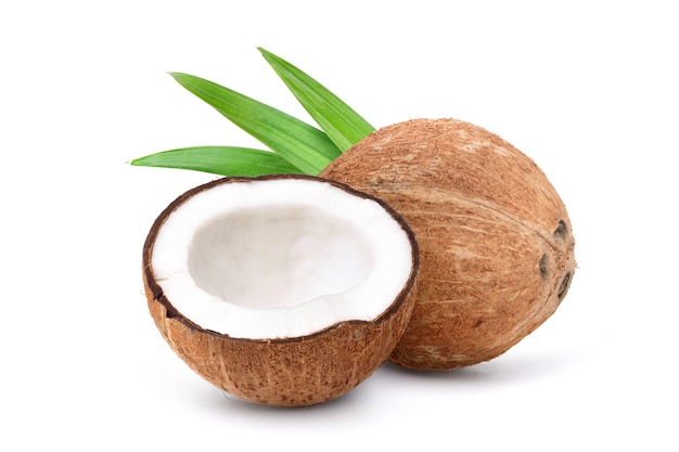 Coconut with cut in half and green leaves  isolated on a white background