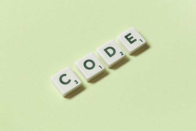 Code formed of scrabble elements on green background