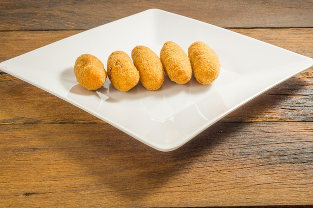 Codfish fritters or codfish cakes, a traditional appetizer in Portugal on white background