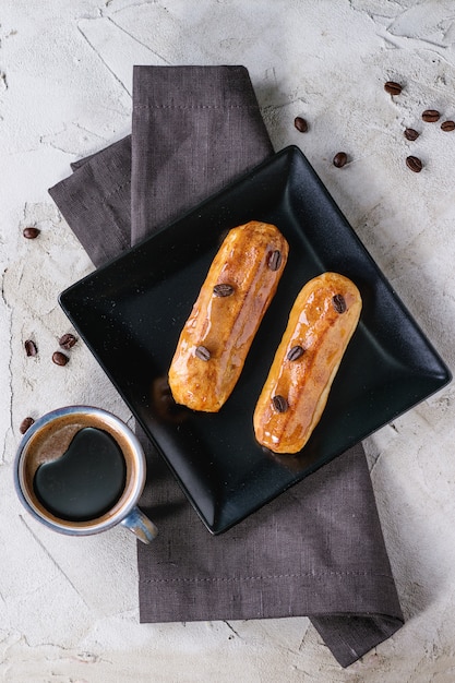 Coffe eclair with cup of coffee