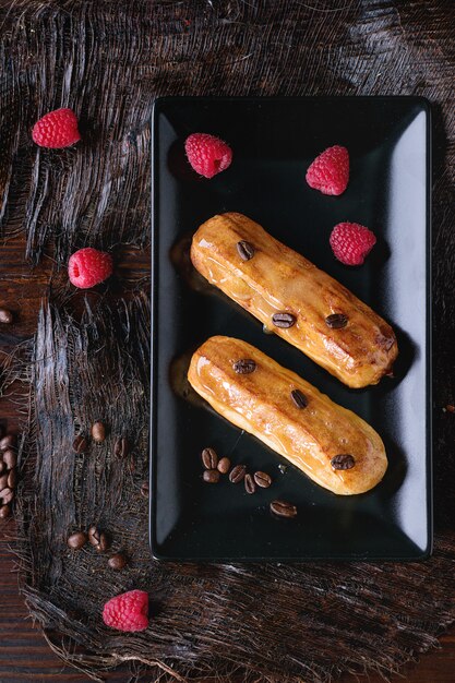 Coffe eclair with raspberries