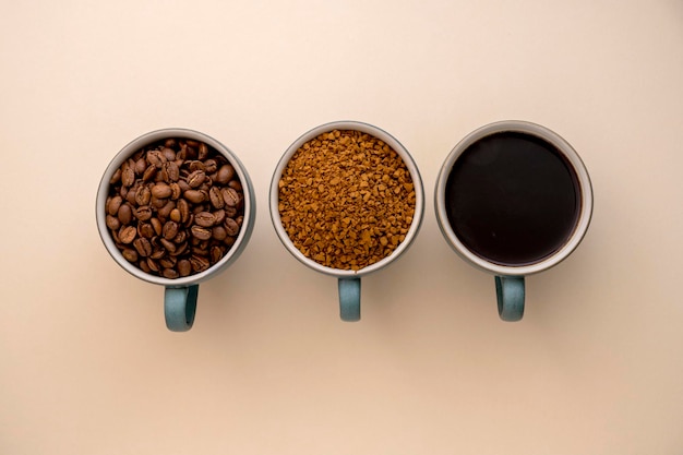 Coffee abstract creative concept Coffee beans roasted soluble coffee and cuffee drink in cups Three types of coffee