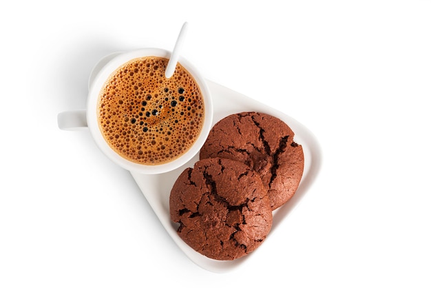 Coffee americano in cup and saucer isolated on a white background. Hot coffee with foam. Coffee with chocolate cookie. High quality photo