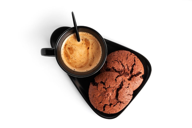 Coffee americano in cup and saucer isolated on a white background. Hot coffee with foam. Coffee with chocolate cookie. High quality photo