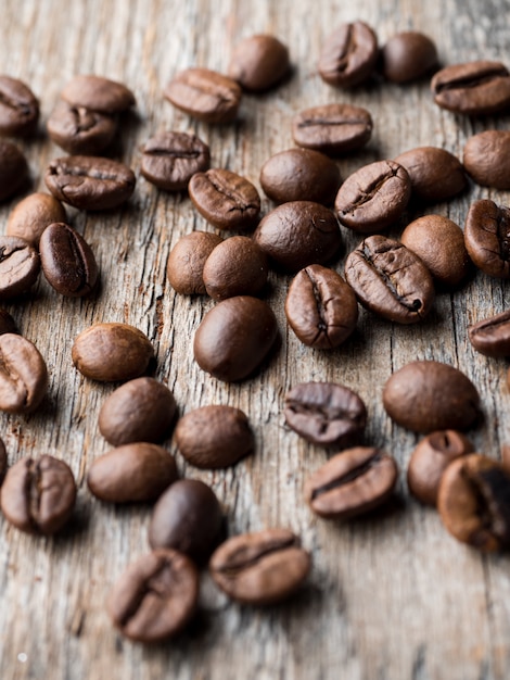 Coffee background. Grain coffee on a rustic wooden background