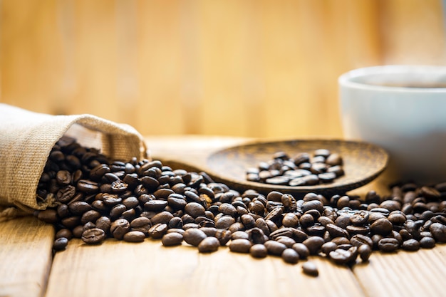 Coffee bean and coffee cup on wooden.