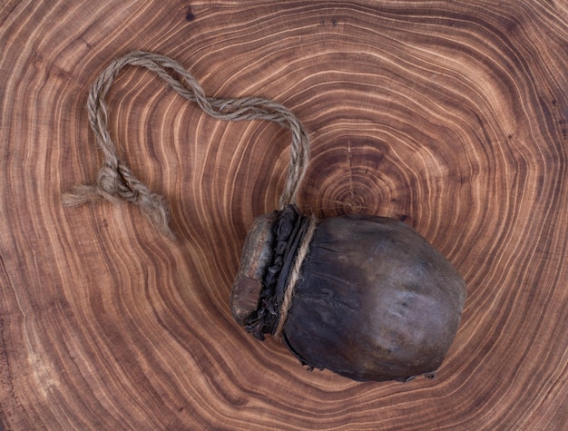 coffee beans in an ancient wooden bottle on a wooden table